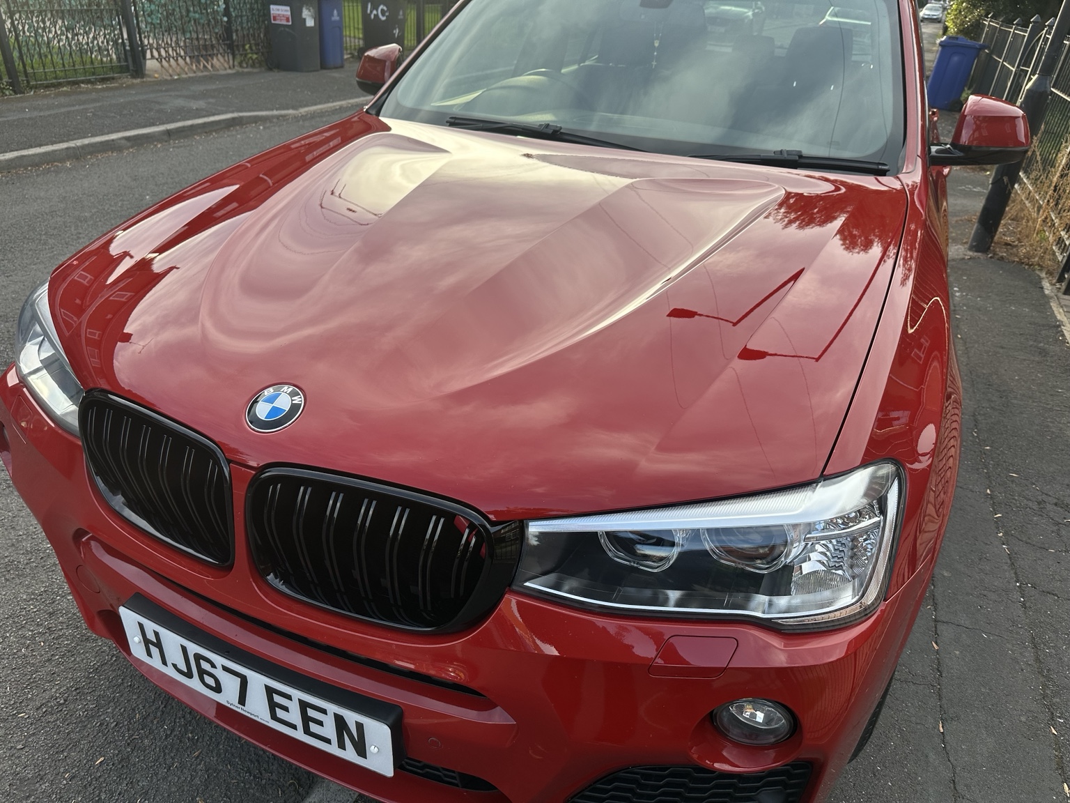 Glossy red BMW bonnet following a VΛULTO Customs paint correction and ceramic coating job